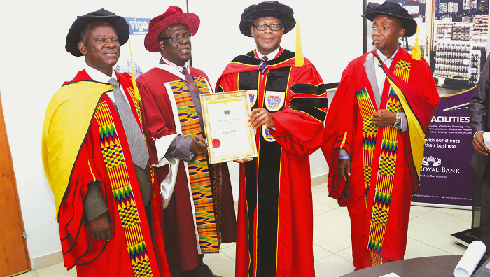 Mr Robert Kow Bentil (2nd right) displaying his certificate of honour